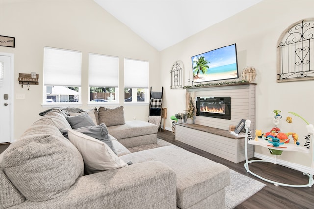 living room featuring hardwood / wood-style flooring, a brick fireplace, and high vaulted ceiling