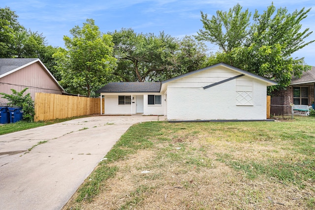 ranch-style house with brick siding, a front yard, and fence