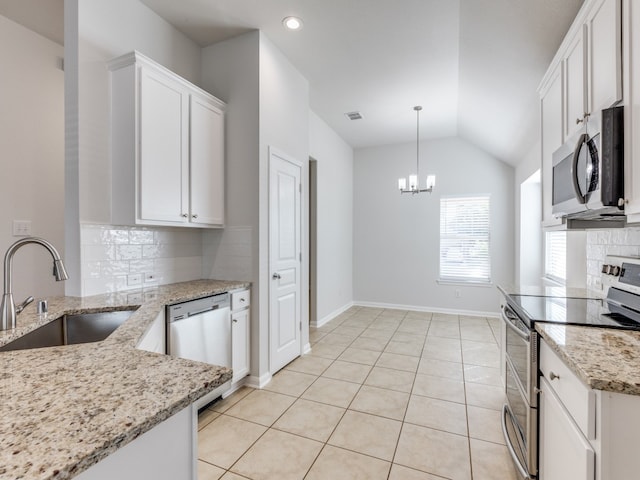 kitchen with backsplash, sink, appliances with stainless steel finishes, lofted ceiling, and white cabinets