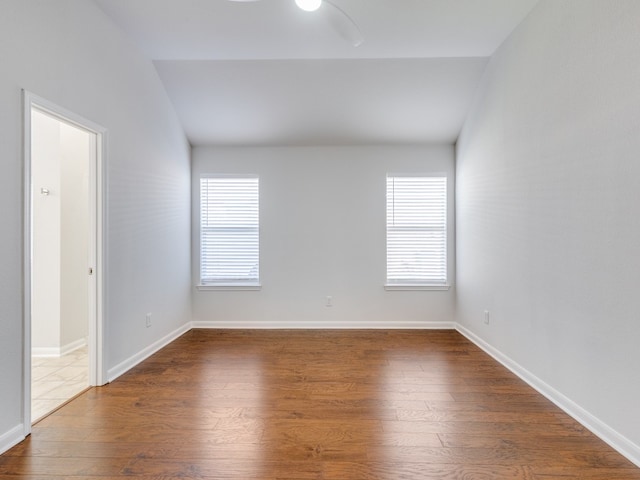 unfurnished room featuring a wealth of natural light, ceiling fan, and hardwood / wood-style flooring