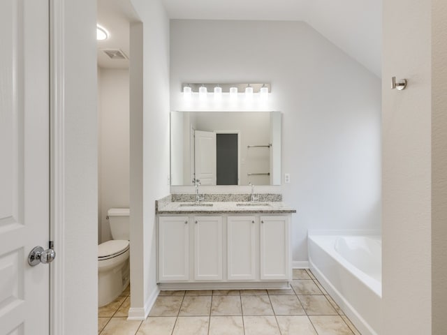 bathroom featuring a bath, tile patterned floors, lofted ceiling, double sink vanity, and toilet