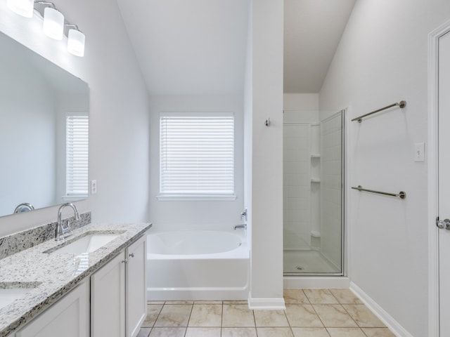 bathroom with plenty of natural light, shower with separate bathtub, dual vanity, and tile patterned floors