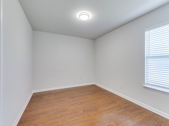 unfurnished room featuring wood-type flooring