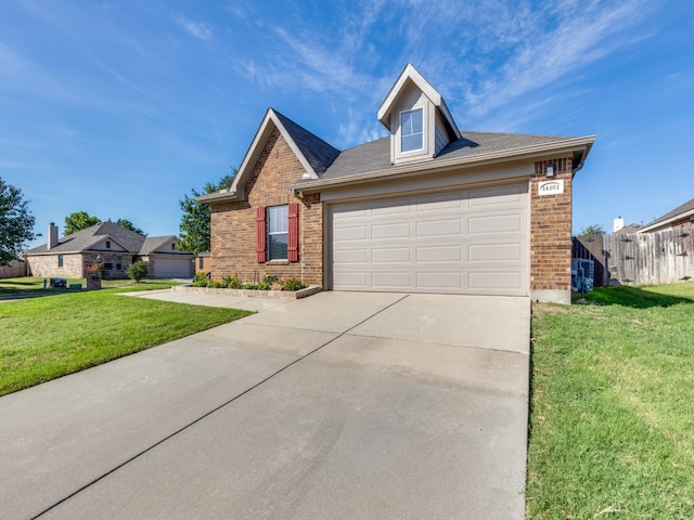 view of front of property with a front yard and a garage