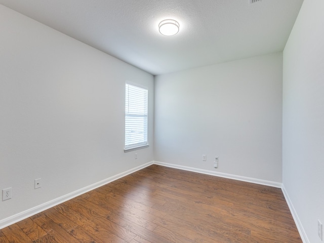 empty room with wood-type flooring