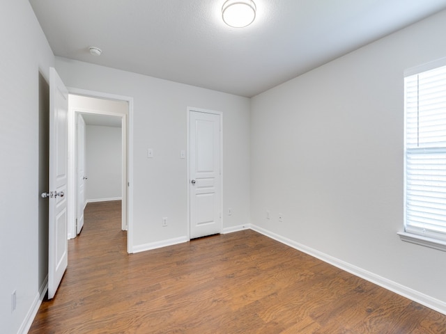 unfurnished bedroom with hardwood / wood-style flooring and a closet