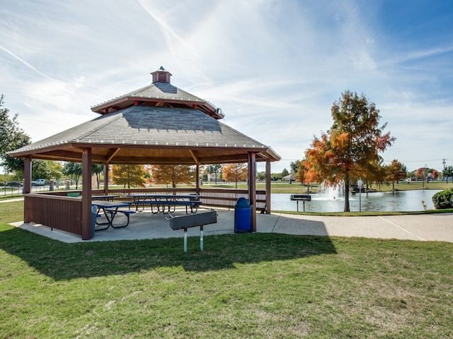 view of community with a gazebo, a water view, and a lawn