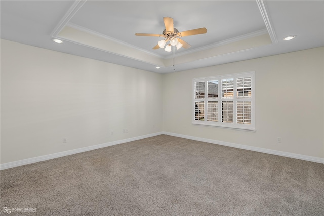 empty room featuring crown molding, carpet floors, ceiling fan, and a tray ceiling