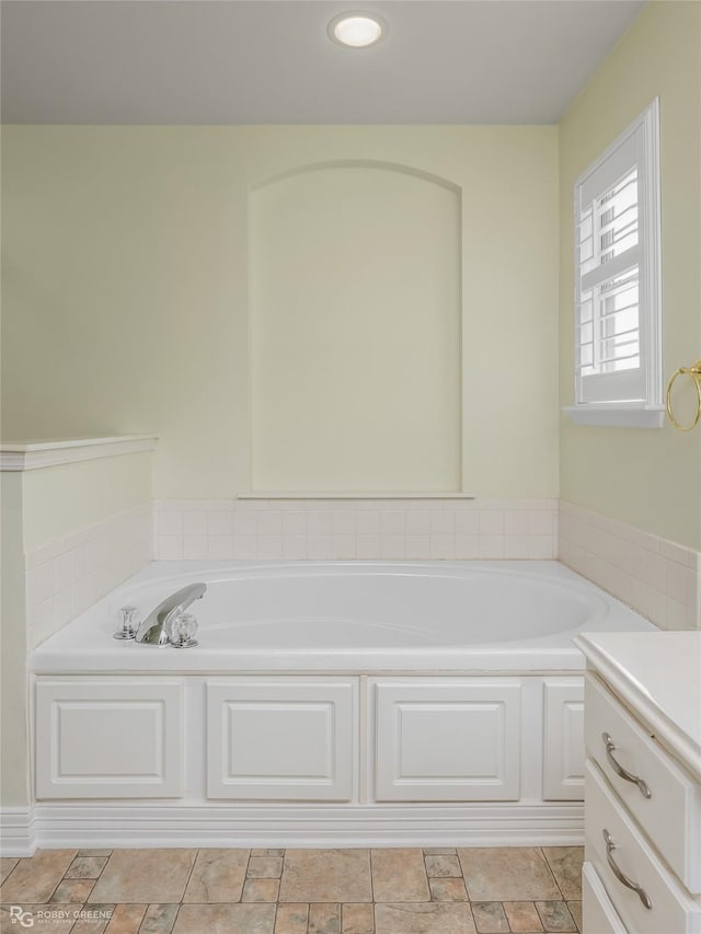 bathroom featuring vanity and a tub