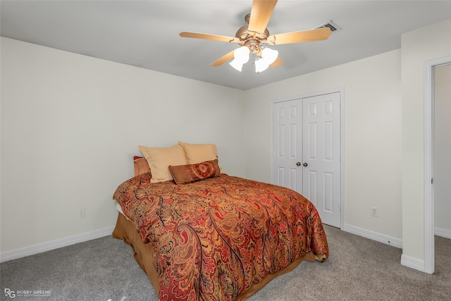 carpeted bedroom with ceiling fan and a closet