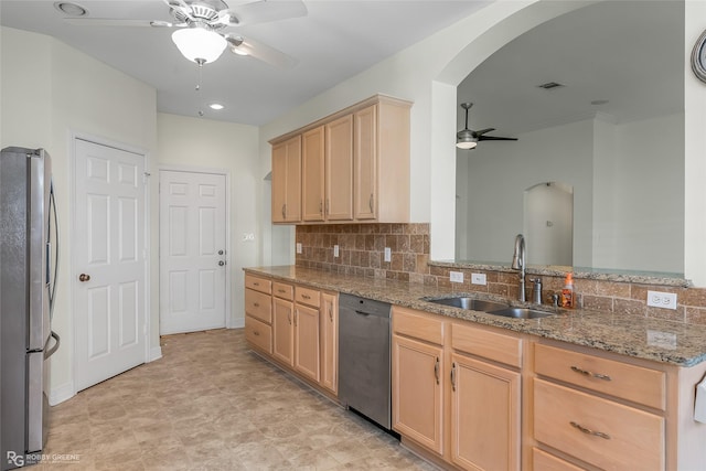 kitchen with light brown cabinetry, sink, light stone counters, ceiling fan, and stainless steel appliances