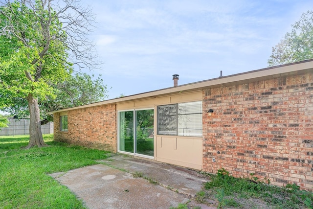 rear view of house featuring a patio and a yard