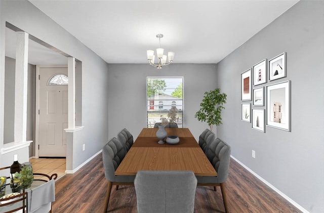 dining space with dark hardwood / wood-style flooring and a chandelier