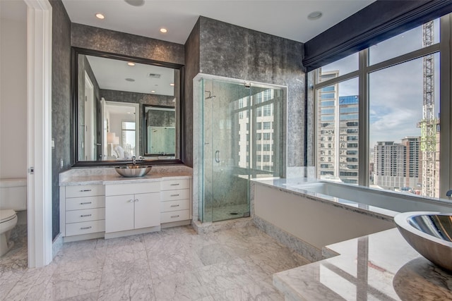 bathroom featuring toilet, vanity, marble finish floor, a shower stall, and a bathtub