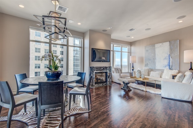 dining room with a fireplace and dark hardwood / wood-style flooring