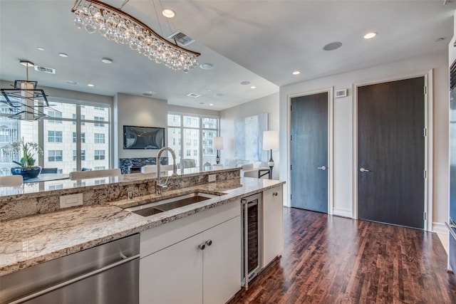 kitchen featuring open floor plan, visible vents, a sink, and dishwasher