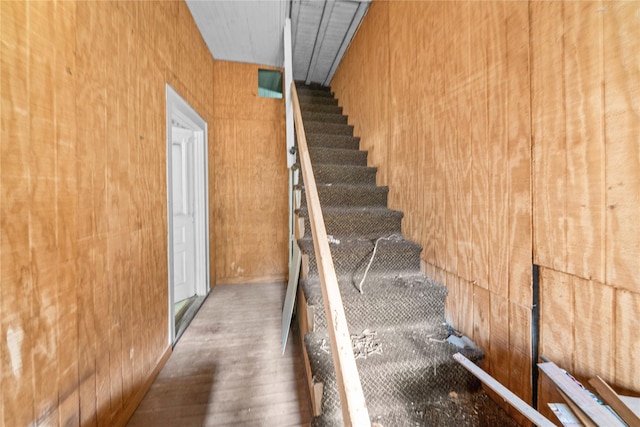 stairs featuring hardwood / wood-style flooring