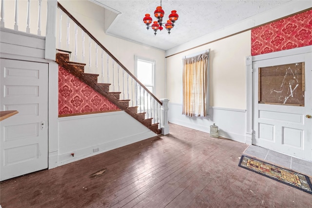 entryway featuring a chandelier, a textured ceiling, and hardwood / wood-style floors