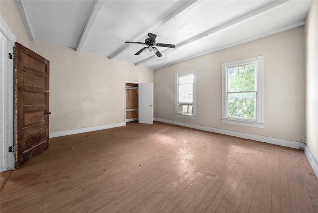 interior space with beamed ceiling, hardwood / wood-style floors, and ceiling fan