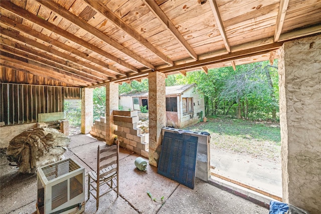 view of patio / terrace featuring heating unit and an outdoor structure