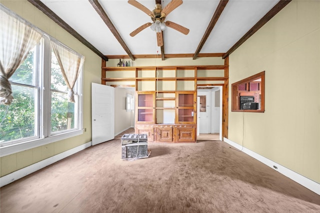 unfurnished room featuring ceiling fan and beam ceiling