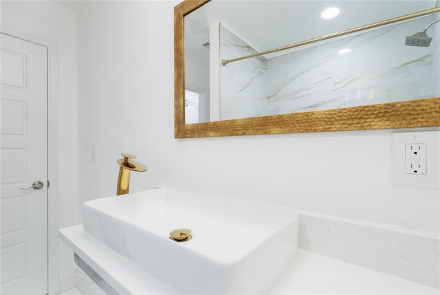 bathroom featuring a shower and a sink