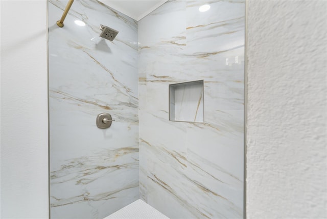 bathroom featuring a marble finish shower