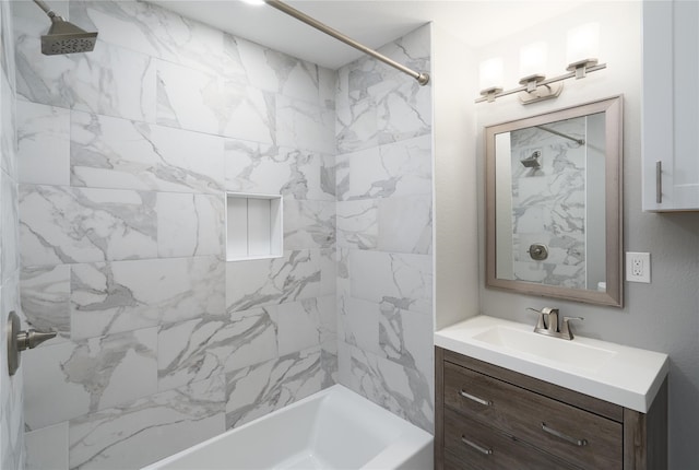 bathroom with vanity and tiled shower / bath