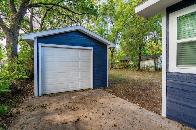 detached garage featuring concrete driveway