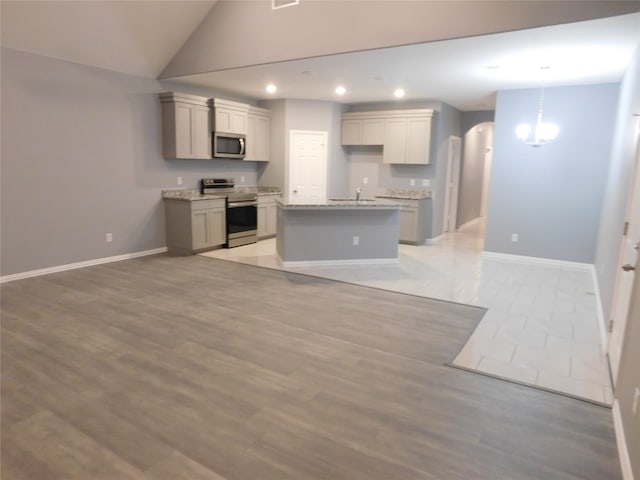 kitchen with sink, light hardwood / wood-style flooring, a center island, and stainless steel appliances