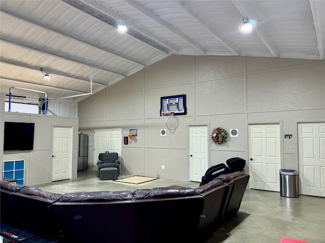 interior space with concrete floors and high vaulted ceiling