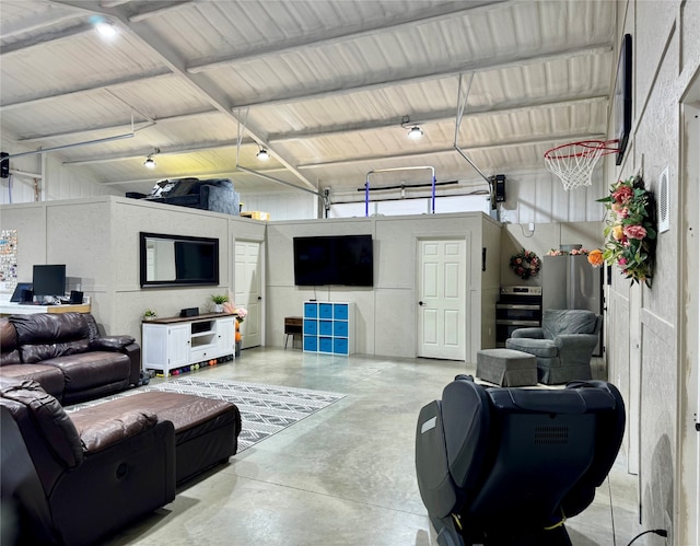 living room featuring a high ceiling and concrete floors