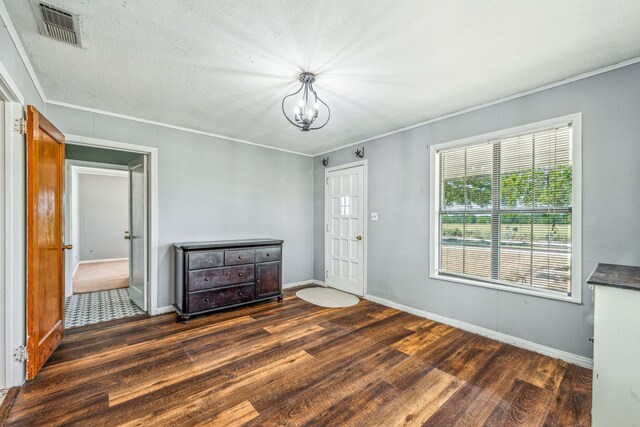 bedroom featuring crown molding, a notable chandelier, and dark hardwood / wood-style flooring