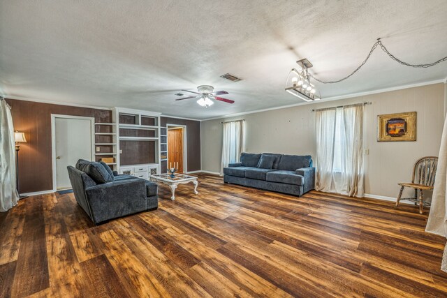 living room featuring a textured ceiling, ceiling fan with notable chandelier, plenty of natural light, and wood-type flooring