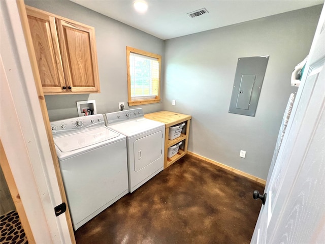 clothes washing area with washing machine and clothes dryer, cabinets, and electric panel