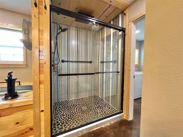 bathroom with an enclosed shower and washer / dryer