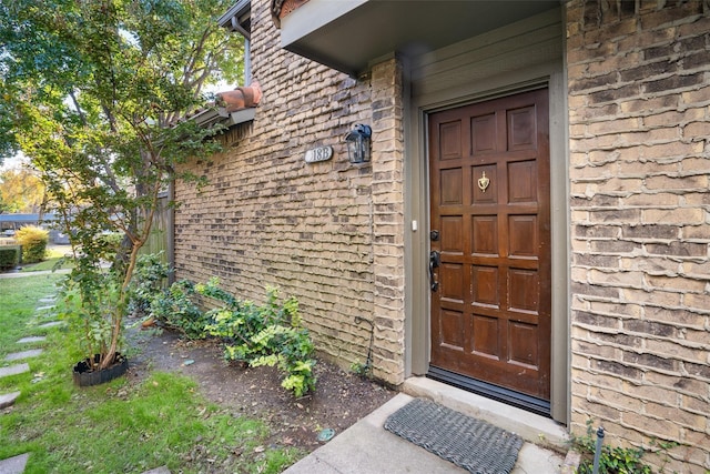 property entrance with stone siding and brick siding