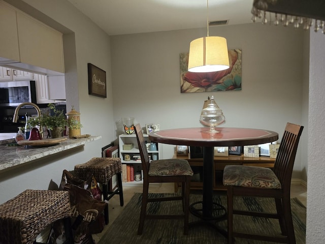 dining space with carpet and visible vents