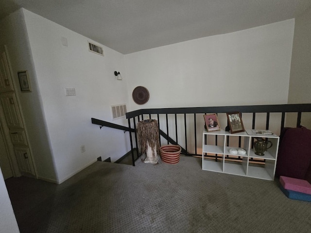 interior space with carpet floors and visible vents