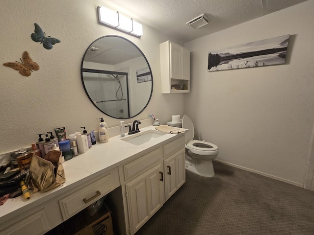 bathroom with visible vents, toilet, a shower with door, a textured ceiling, and vanity