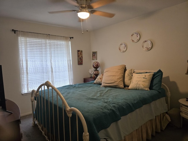 bedroom featuring a ceiling fan and dark carpet