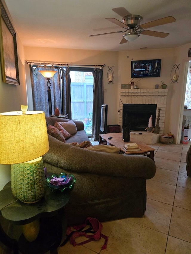 tiled living area featuring a ceiling fan and a fireplace