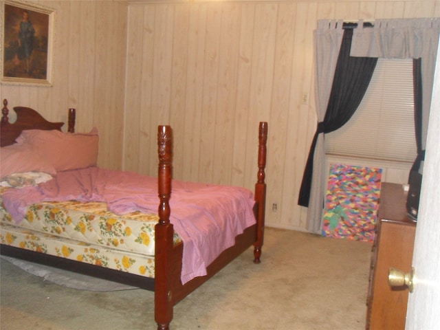 carpeted bedroom with wood walls