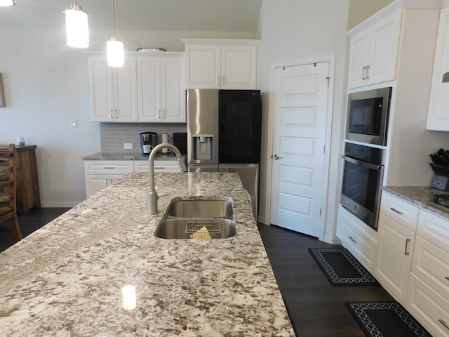 kitchen featuring backsplash, dark hardwood / wood-style floors, white cabinets, appliances with stainless steel finishes, and sink