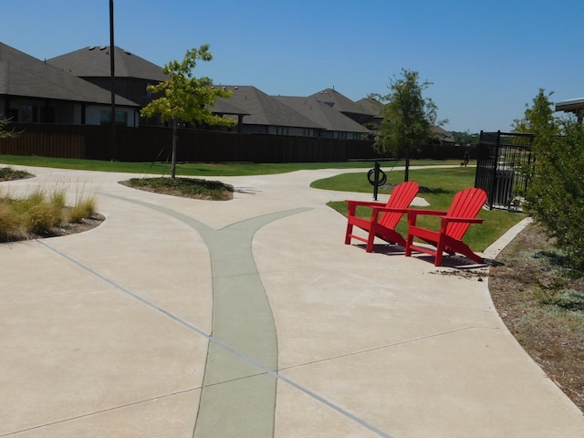 surrounding community with a patio area and a lawn