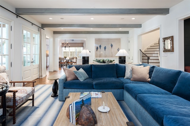 living room featuring beam ceiling and wood-type flooring