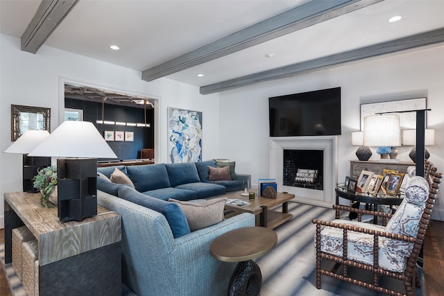 living room featuring beam ceiling and hardwood / wood-style floors