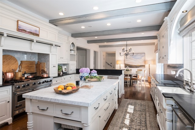 kitchen with decorative backsplash, dark hardwood / wood-style floors, a kitchen island, beam ceiling, and appliances with stainless steel finishes