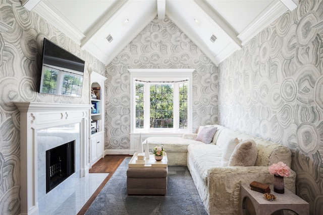 living room with high vaulted ceiling, ornamental molding, wood-type flooring, beam ceiling, and a fireplace