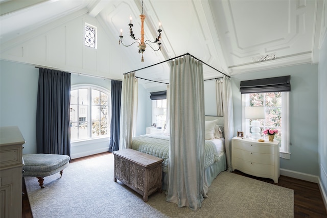 bedroom with vaulted ceiling with beams, hardwood / wood-style flooring, an inviting chandelier, and multiple windows